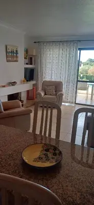 a kitchen and living room with a table with a plate at AA Apartamento Solar dos Pinheiros in Vilamoura