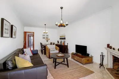 a living room with a couch and a tv at V2 a 400 m da Praia da Falésia in Albufeira