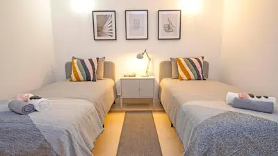 two beds sitting next to each other in a room at Villa Del Sol by Algarve Vacation in Quarteira