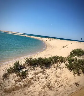 a sandy beach with the ocean in the background at Villa Cristipaulo in Praia de Faro