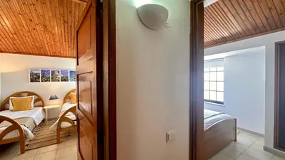 a small bedroom with a bed and a room with a table at Buganvilia by Check-in Portugal in Albufeira