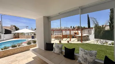 a house with a patio with a pool and a yard at Buganvilia by Check-in Portugal in Albufeira