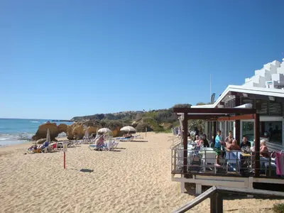 a group of people sitting on the beach at Buganvilia by Check-in Portugal in Albufeira
