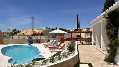 a backyard with a swimming pool and lounge chairs at Buganvilia by Check-in Portugal in Albufeira