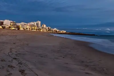 a view of a beach with buildings and the ocean at Vacation Apartment in Quarteira in Cavacos