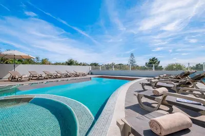 a swimming pool with chaise lounges and chairs at Villa Dubai by Algarve Vacation in Albufeira