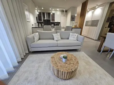 a living room with a couch and a table at Paraíso Forte Novo in Quarteira