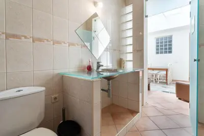 a bathroom with a toilet and a sink and a mirror at Blife Alicya private rooms in Faro