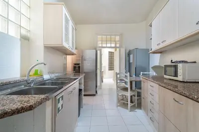 a kitchen with a sink and a refrigerator at Blife Alicya private rooms in Faro