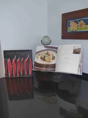 a refrigerator with a book and a plate of food at Luxury Private 5 bedroom Villa pool, golf, Algarve in Quarteira