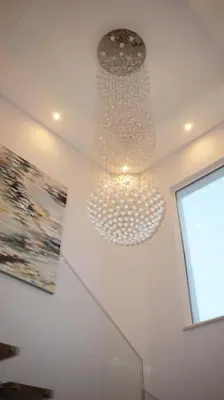 a chandelier hanging from the ceiling in a room at Luxury Private 5 bedroom Villa pool, golf, Algarve in Quarteira