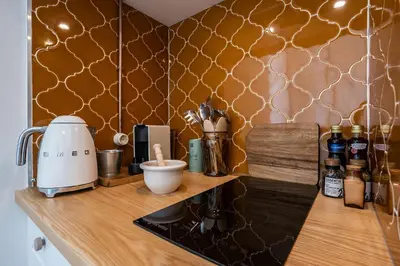 a kitchen with a counter with a coffee maker on it at Dona Simone Boutique Suites & Studios - by @ rita's place in Faro