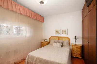 a bedroom with a bed and a dresser and a window at Apartarment Azur in Albufeira