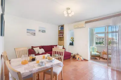 a living room with a table and a couch at Apartarment Azur in Albufeira