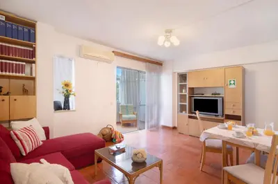 a living room with a red couch and a table at Apartarment Azur in Albufeira