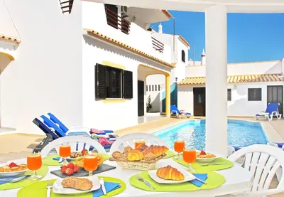 a table with food on it in front of a villa at Villa Ibiza by Algarve Vacation in Guia