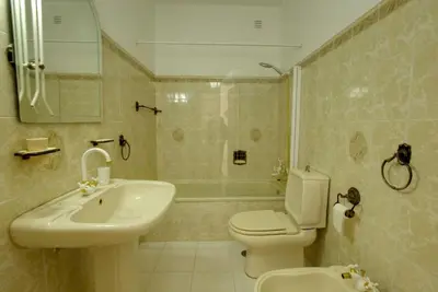 a bathroom with a sink and a toilet and a shower at Townhouse in Quarteira in Quarteira