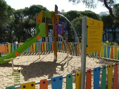 a playground with a slide in the sand at Calm Sunny Apartment near Falésia Beach in Albufeira
