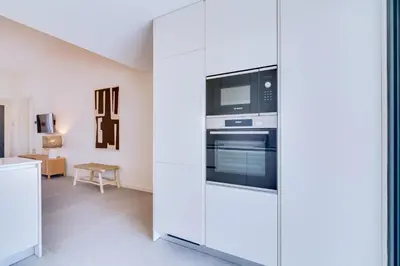 a kitchen with a white refrigerator and a microwave at AL - Villas Country Club in Vilamoura