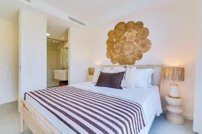 a bedroom with a large bed and a large chandelier at AL - Villas Country Club in Vilamoura