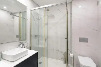a bathroom with a glass shower and a sink at ALICE - Vilamoura in Vilamoura