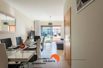 a dining room with a long table with chairs at #226 Vila LII by Home Holidays in Albufeira