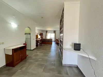 a room with a kitchen and a living room at Albufeira Tropical View 1 With Pool by Homing in Albufeira