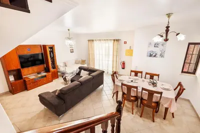 a living room with a couch and a table at Villa Krishan Albufeira - Private Pool in Albufeira