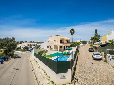 a house with a swimming pool on a street at Villa Krishan Albufeira - Private Pool in Albufeira