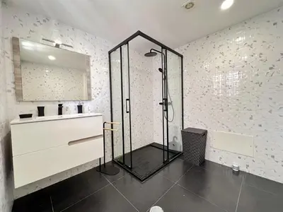 a bathroom with a shower and a sink and a mirror at Albufeira Stylish 3 by Homing in Albufeira