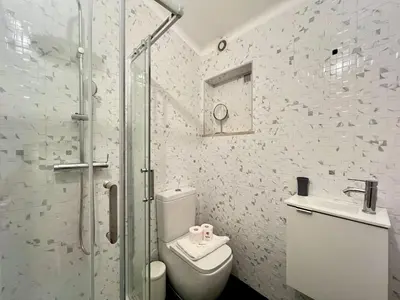 a bathroom with a shower and a toilet and a sink at Albufeira Stylish 3 by Homing in Albufeira
