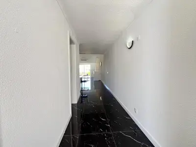 an empty hallway with a clock on the wall at Albufeira Stylish 3 by Homing in Albufeira