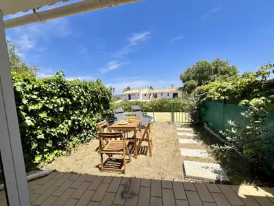 a patio with a table and chairs in a yard at Albufeira Stylish 3 by Homing in Albufeira