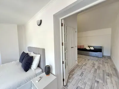 a living room with a couch and a bedroom at Albufeira Stylish 3 by Homing in Albufeira