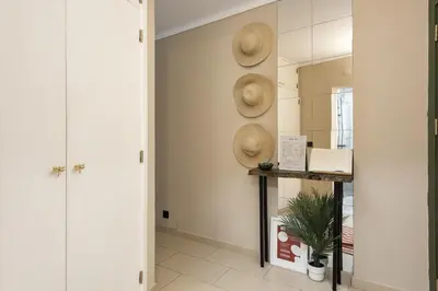 a hallway with two straw hats on the wall at Dona Marieta House in Vilamoura