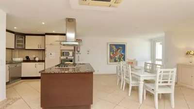a kitchen and dining room with a table and chairs at Marina parque CD 68 - Cleverdetails - private pool, few steps to the marina in Vilamoura