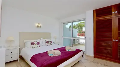 a bedroom with a bed and a large window at Marina parque CD 68 - Cleverdetails - private pool, few steps to the marina in Vilamoura