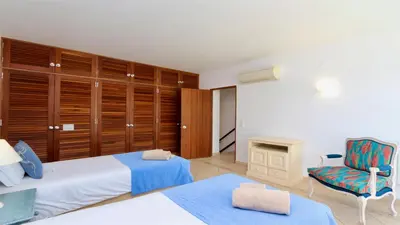 a bedroom with two beds and a chair at Marina parque CD 68 - Cleverdetails - private pool, few steps to the marina in Vilamoura