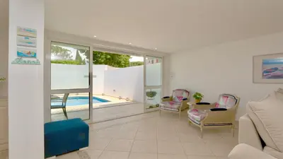 a living room with a couch and chairs and a pool at Marina parque CD 68 - Cleverdetails - private pool, few steps to the marina in Vilamoura