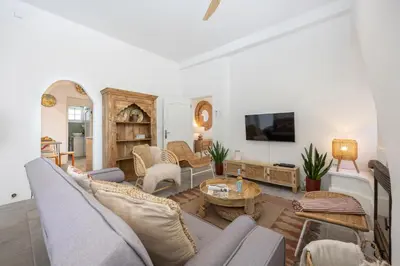 a living room with a couch and a table at Casa Ladeira in Loulé