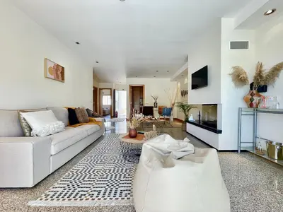a living room with a couch and a fireplace at Casa Falésia - 150 meters from Falésia Beach in Albufeira