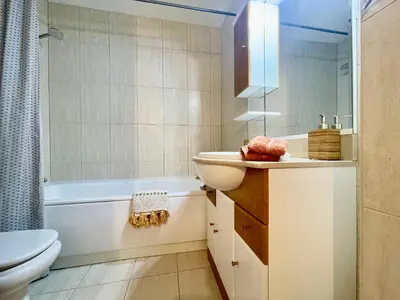 a bathroom with a sink and a toilet and a tub at Casa Falésia - 150 meters from Falésia Beach in Albufeira