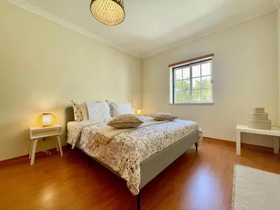 a bedroom with a bed and a window at Casa Falésia - 150 meters from Falésia Beach in Albufeira