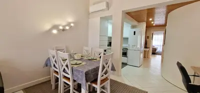 a kitchen and dining room with a table and chairs at Victory Village Club,Quinta do Lago in Loulé