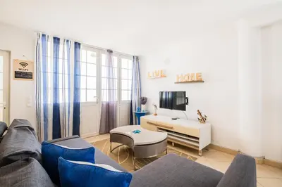 a living room with a couch and a tv at Daisy 2 Bedroom Apartment in Albufeira