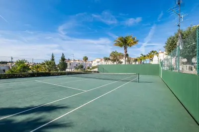 a tennis court with a tennis racket on it at Daisy 2 Bedroom Apartment in Albufeira