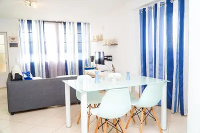 a dining room with a white table and white chairs at Daisy 2 Bedroom Apartment in Albufeira