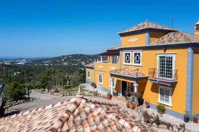 a yellow house with a tile roof at AL Monte Lusitano in Loulé