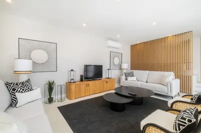 a living room with a couch and a tv at Valbom Luxury Village in Galé