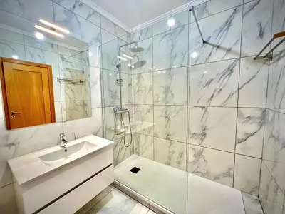 a bathroom with a sink and a shower at Vilamoura Prestige 2 With Pool by Homing in Vilamoura